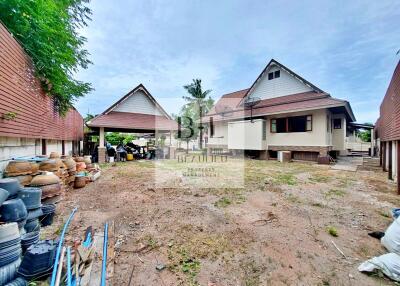 Backyard and exterior view of house with multiple gable roofs