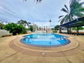 Outdoor pool area with palm trees