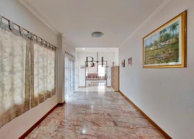 Bright living space with marble floor and wall art