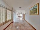 Bright living space with marble floor and wall art