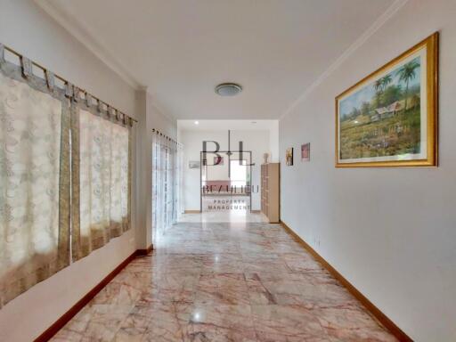 Bright living space with marble floor and wall art