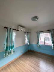 Well-lit bedroom with windows and curtains