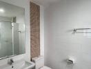 Modern bathroom with white tiles and fixtures
