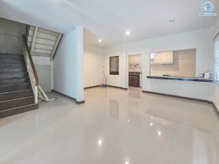 Open living area with stairs and kitchen