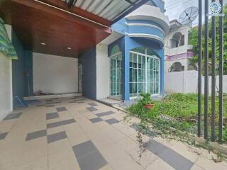 Modern property facade with driveway and garden