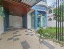 Modern property facade with driveway and garden