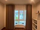 Room with wooden flooring, large window with curtains, and shelf