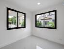 A bright bedroom with large windows and tile flooring