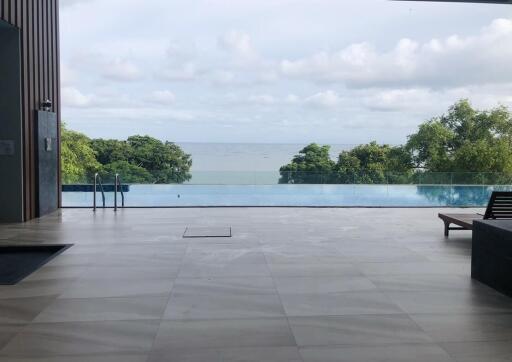 Infinity pool view of the ocean and lush greenery