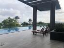 Outdoor pool area with lounge chairs and scenic view