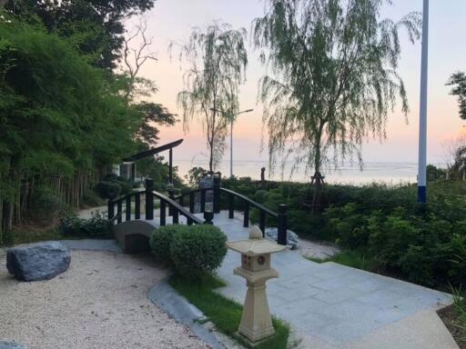 Serene garden with a bridge overlooking a body of water