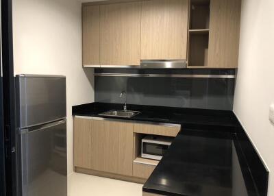 Modern kitchen with wooden cabinets and black countertop