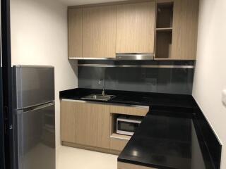 Modern kitchen with wooden cabinets and black countertop