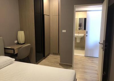 Bedroom connected to bathroom with modern decor