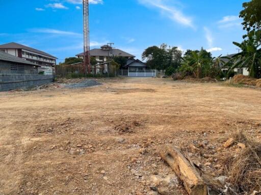 Vacant land with clear skies and surrounding houses