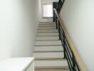 Modern staircase with white walls and wooden steps