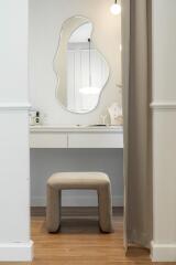 Dressing table with abstract mirror and beige stool