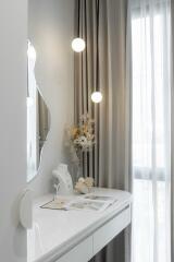 Cozy bedroom vanity corner with modern mirror and hanging lights