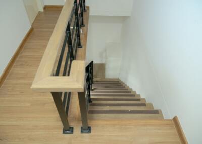 Wooden staircase with black railing