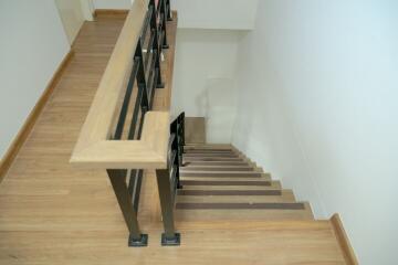 Wooden staircase with black railing