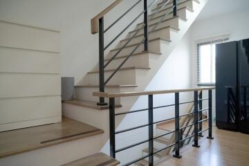 Modern staircase with wooden steps and metal railing