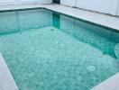 Outdoor swimming pool with tiled flooring