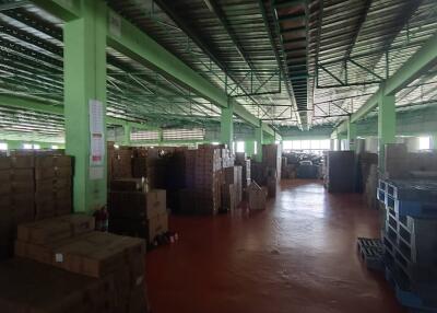 Spacious warehouse with stacked boxes and pallets