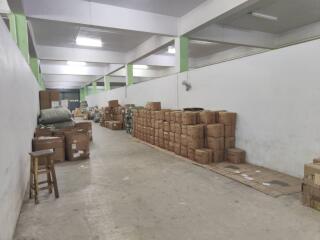 Storage area with numerous cardboard boxes and a stool