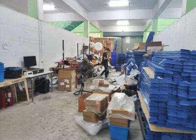 Interior of a warehouse with various boxes and industrial equipment