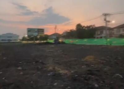 Vacant land during sunset with nearby infrastructure