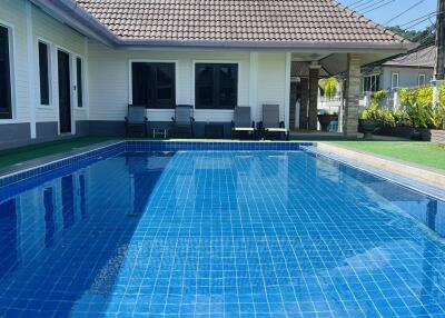 Swimming pool area with seating in a residential property