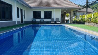 Swimming pool area with seating in a residential property