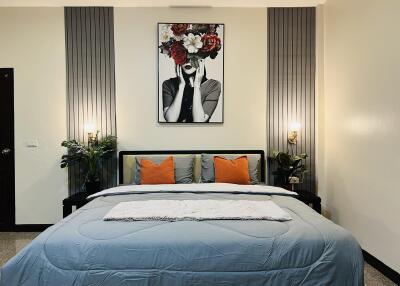 Modern bedroom with double bed and stylish wall art