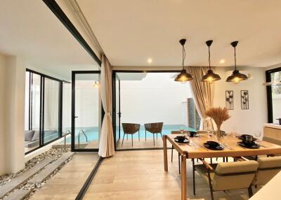 Modern dining area with view of private pool