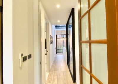 Modern hallway with wooden flooring and glass door