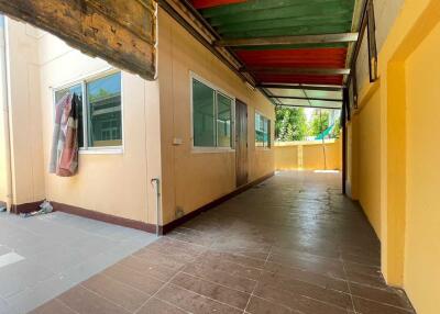 Outdoor walkway with tiled flooring and windows