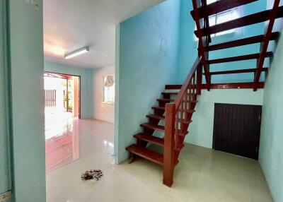 Main living area with staircase and access to exterior