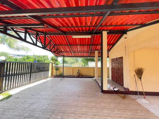 Covered outdoor area with red roof and tiled floor