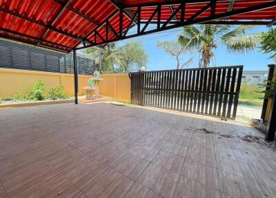 Covered patio area with gate and garden