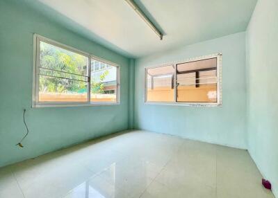 Empty room with large windows and tiled floor