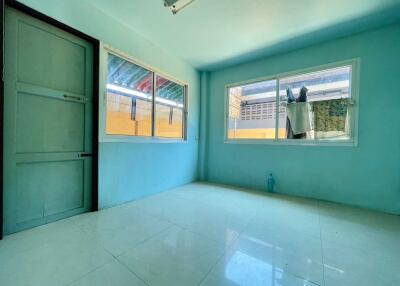 Empty room with large windows and tiled floor