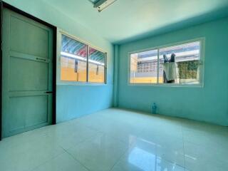 Empty room with large windows and tiled floor