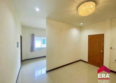 Spacious living area with chandelier and wooden door