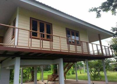 Two-story house with raised main floor and veranda