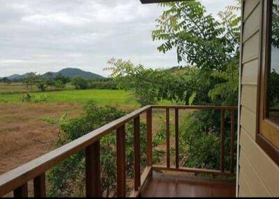 balcony with view of green fields and hills