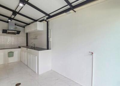 Modern kitchen with white cabinetry and stainless steel appliances