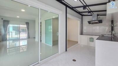 Modern kitchen with white cabinets and open living space