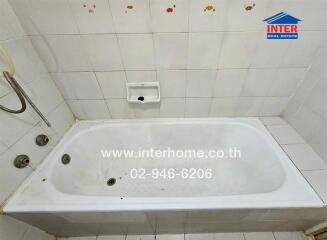 Bathroom with bathtub and shower fixture