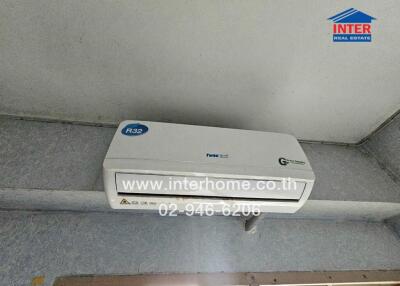 Wall-mounted air conditioning unit in room