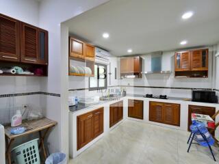 Spacious modern kitchen with wooden cabinets and ample lighting